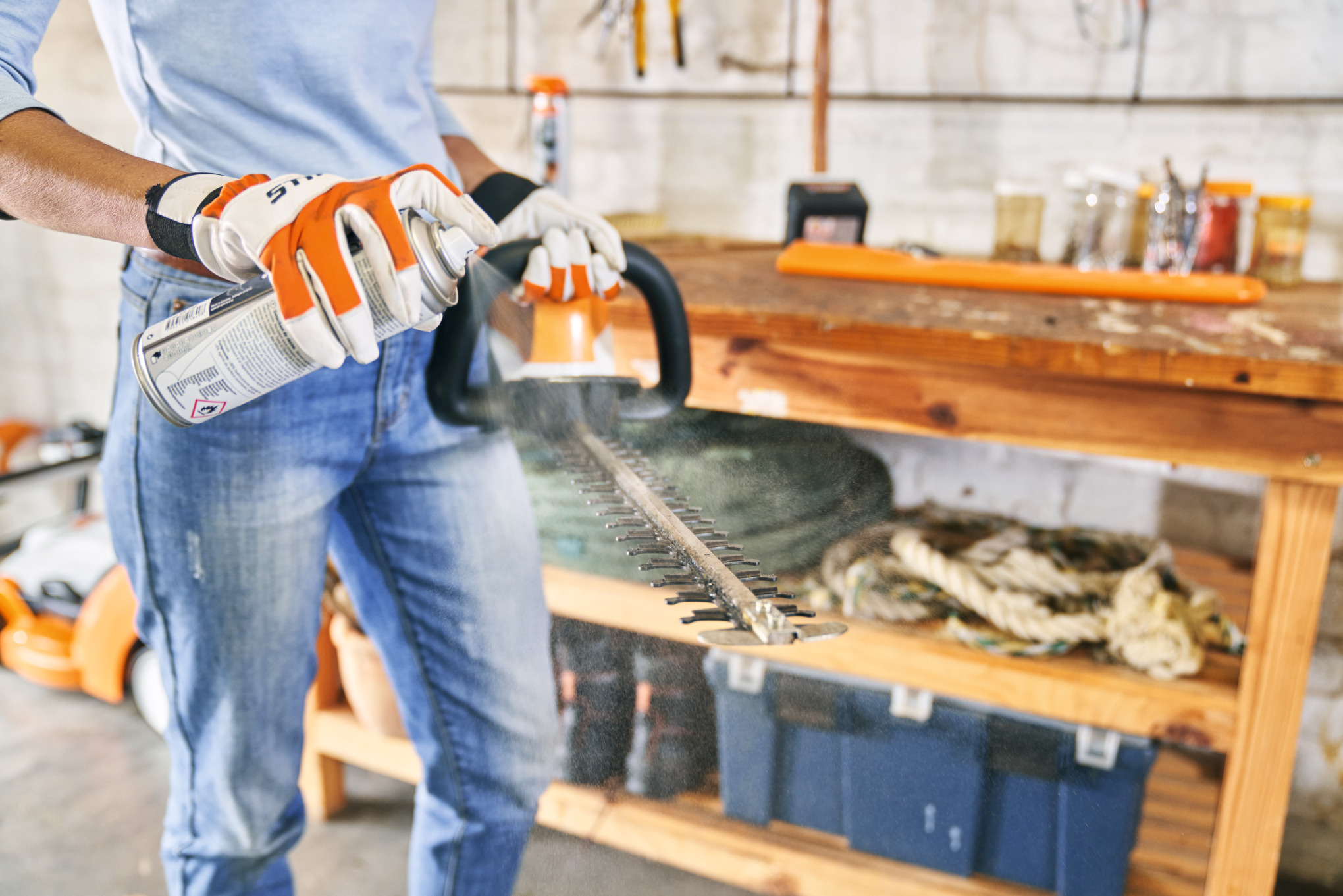 Woman cleaning hedge trimmer blades