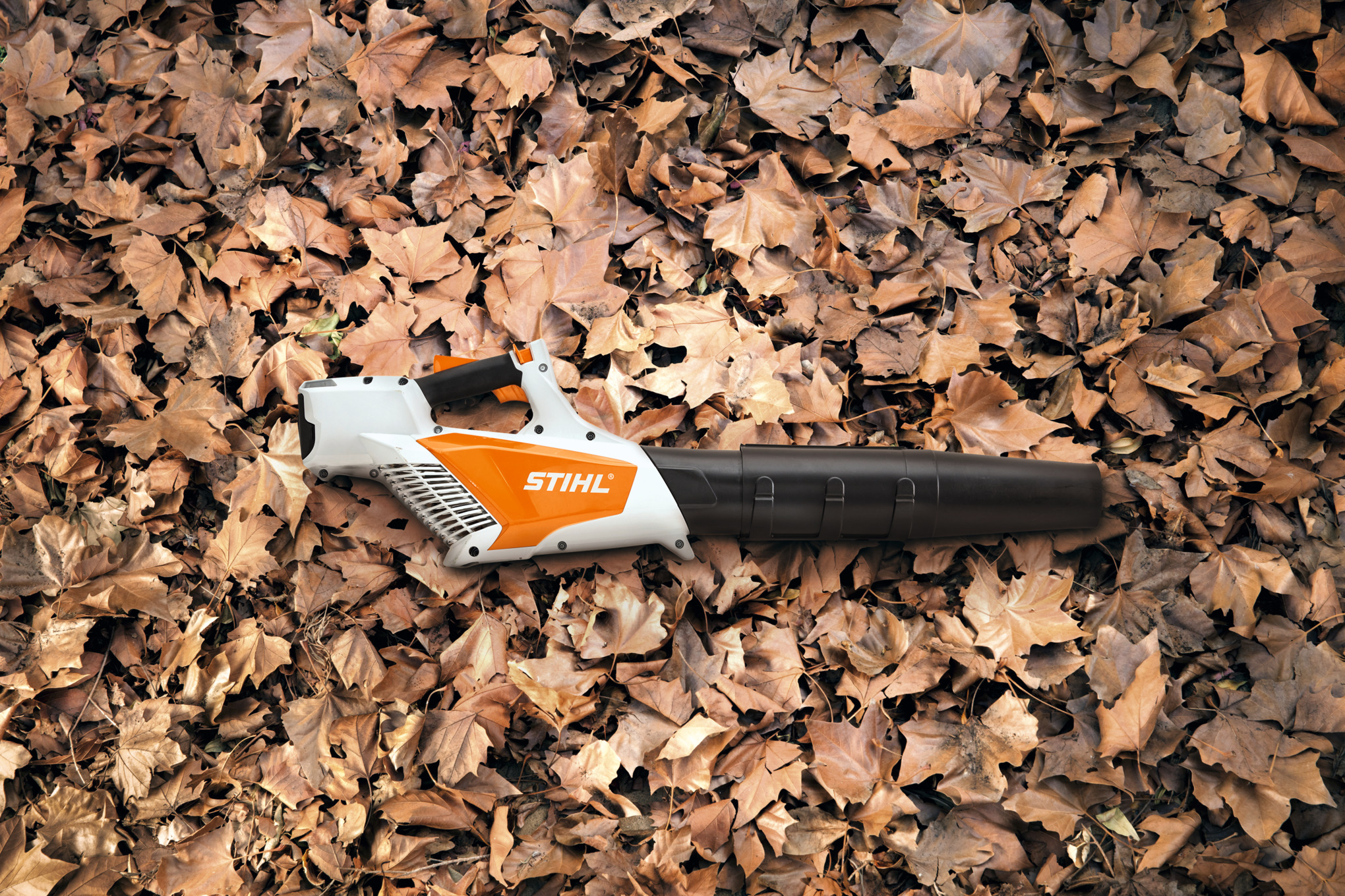 Woman using a STIHL BGA 45 Blower in her backyard