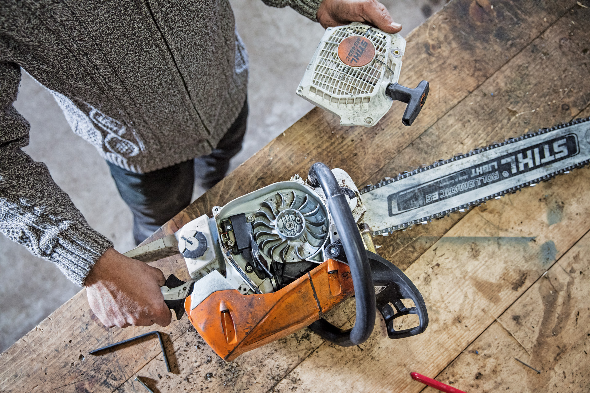 A STIHL MS 462 C-M petrol chainsaw on a bench with the cylinder cover removed