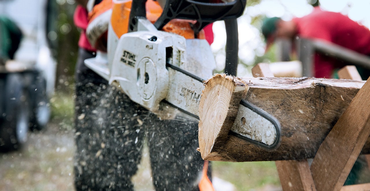 man chopping woods with a chainsaw 